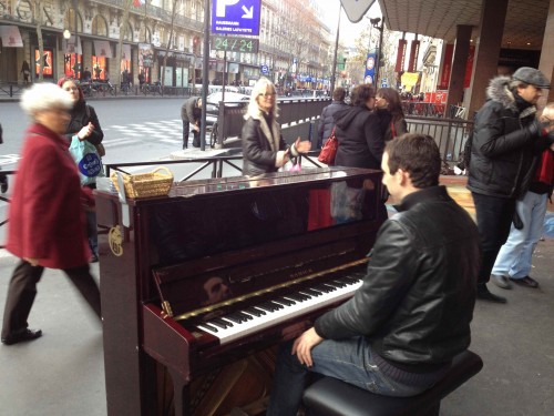 man playing piano on street paris december 2011